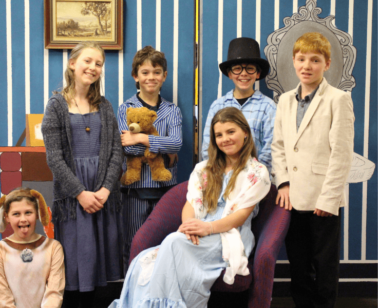 A group of six students dressed to be part of a school performance, Peter Pan.